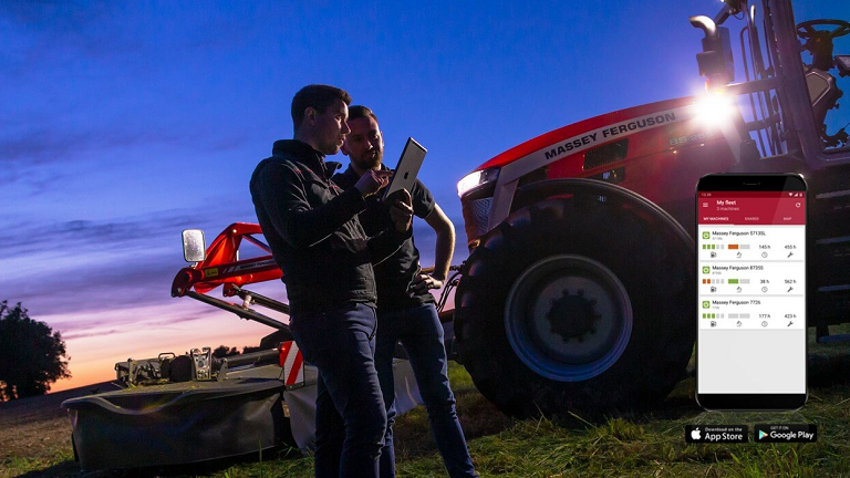 Men looking at tablet in a farm field 