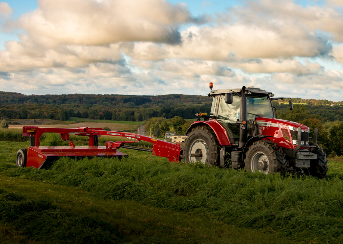 Massey Ferguson 1300 series disc mower with tractor in field