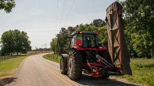 Massey Ferguson Pro series disc mower with tractor on road