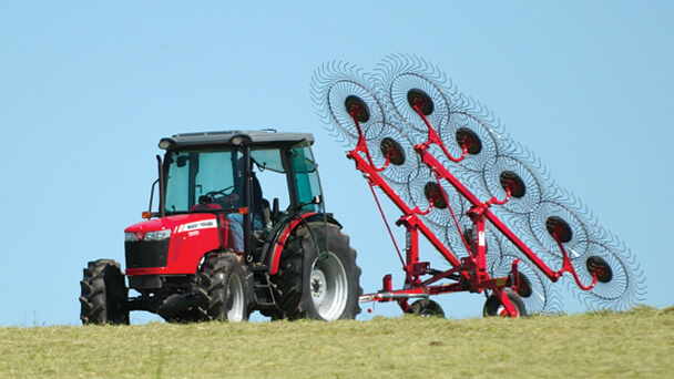 Massey Ferguson 1500 vertical fold rake with tractor with blue sky