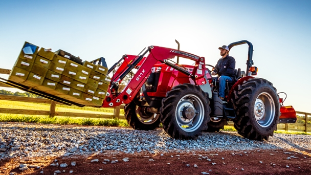 man riding Massey Ferguson 2600 H tractor with loader