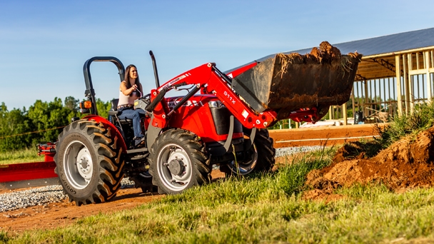 woman riding Massey Ferguson 2600 H tractor with loader