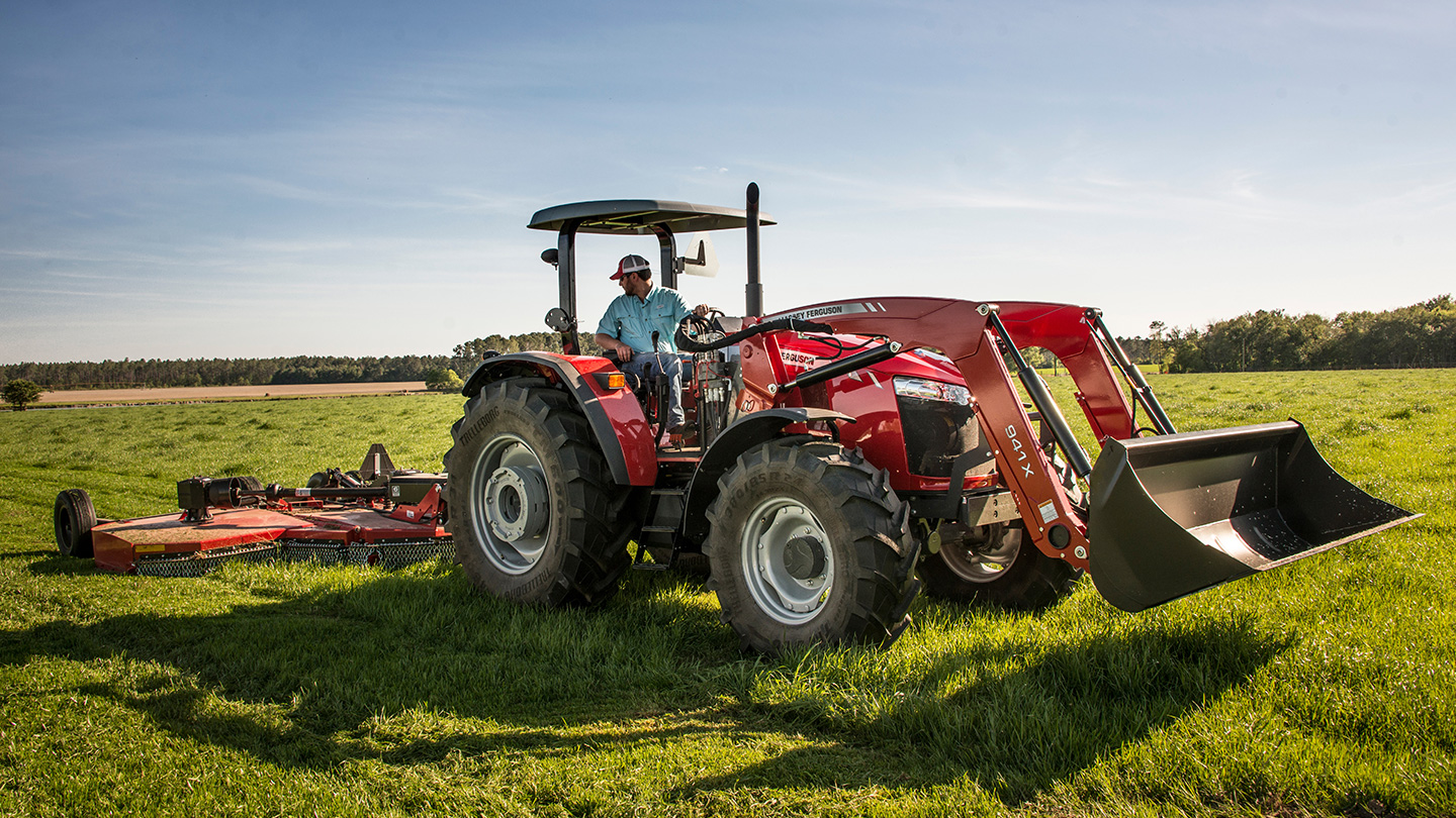 Massey Ferguson 5700 tractor with multiple attachments in field