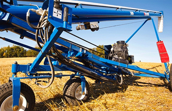 Heavy-duty Brandt EZMover frame with rugged wheels, enhancing auger maneuverability in rough field conditions.