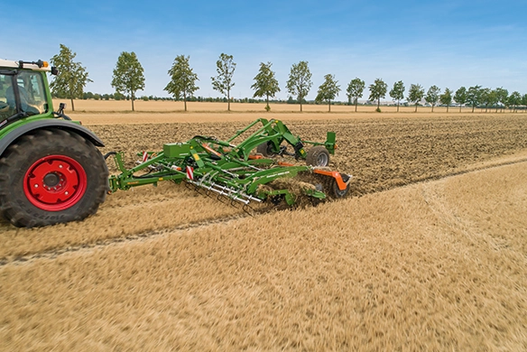 Amazone CatrosXL 6003 tillage being pulled through field by a Fendt tractor.